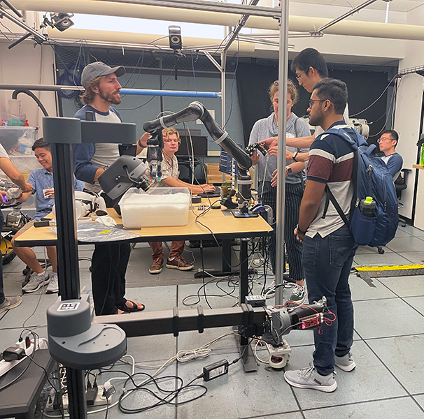 Symposium attendees learn how tactile sensing and wearable haptic displays can enhance teleoperation of remote robots in the UCLA Biomechatronics Lab.
