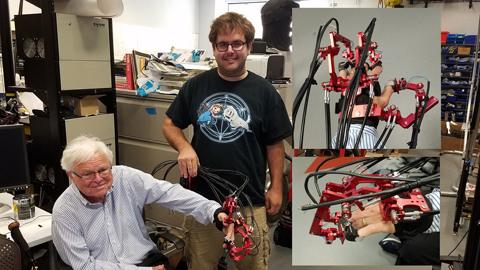 Graduate student Peter Ferguson tests a new design of an exoskeleton hand with stroke patient Fred Schwedner at the UCLA Bionics lab.